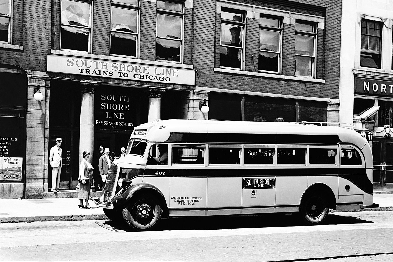 Chicago, South Shore & South Bend Railroad Bus #407 picking up and discharging passengers. Date and location  are unknown. On the front of the bus overhead it reads "Benton Harbor" and "St. Joseph". (8x12)