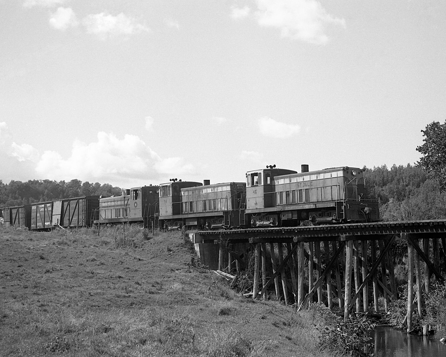 St. Johnsbury & Lamoille County Railroad 70 tonners #46, 54 & Montpelier & Barre #19 on train #74 near East Fairfield, Vermont. Mid to late 1960's. (8x10)